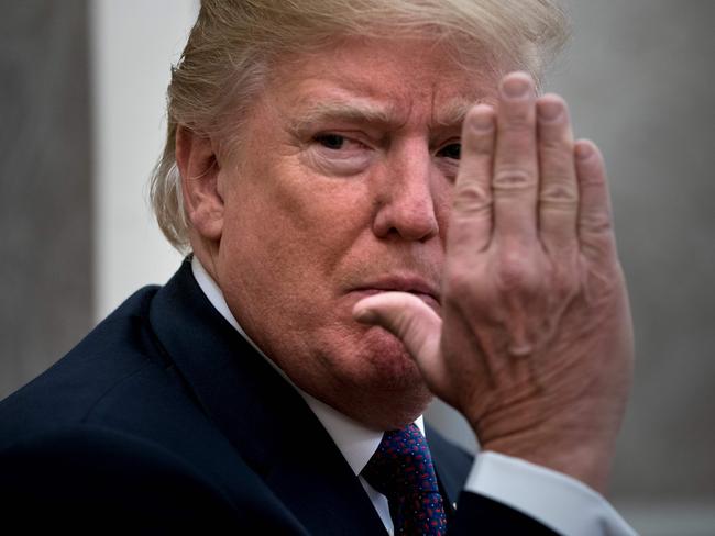 US President Donald Trump gestures as he pauses while making a statement for the press before a meeting with Governor of Puerto Rico Ricardo Rossello and others in the Oval Office of the White House October 19, 2017 in Washington, DC. / AFP PHOTO / Brendan Smialowski