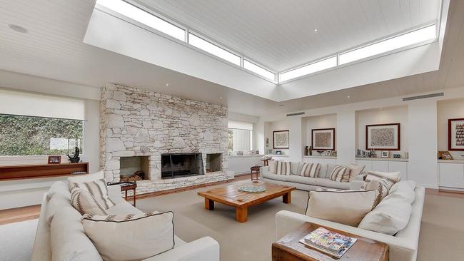 A unique fireplace graces the home’s central living zone.