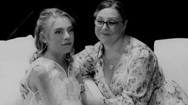 Gold Coast melanoma campaigner Ashleigh Hale (nee Simrajh) in the arms of her mother Tracey Simrajh at the reception of her wedding.