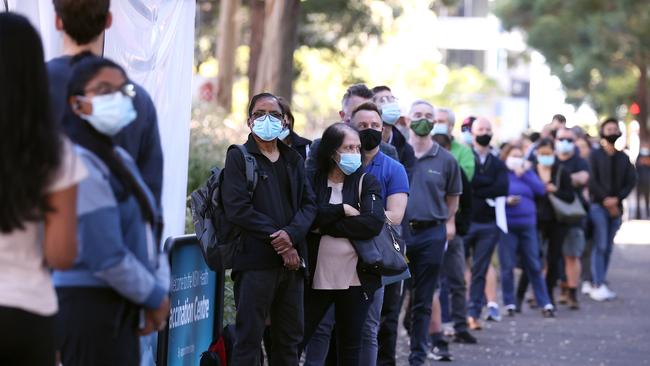 People are seen queuing to enter a mass COVID-19 vaccination hub on May 10, 2021 in Sydney, Australia. The mass vaccination centre at Sydney Olympic Park is equipped to administer 30,000 vaccine doses a week or around 5,000 vaccinations per day. (Photo by Mark Kolbe/Getty Images)