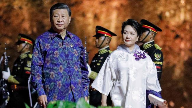 China's President Xi Jinping and his wife Peng Liyuan walk at the welcoming dinner during the G20 Summit in Bali. Picture: AFP