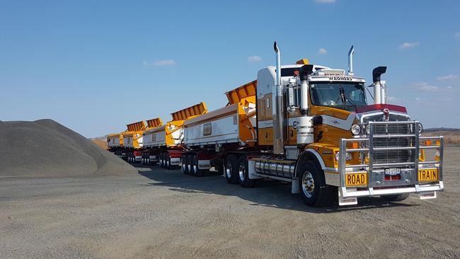 Wagners truck in front of pile of grey material