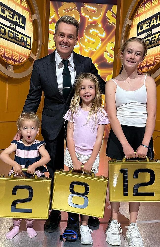 Grant Denyer and his three daughters - Sailor, Scout and Sunday - on the set of Deal or No Deal. Picture: Instagram