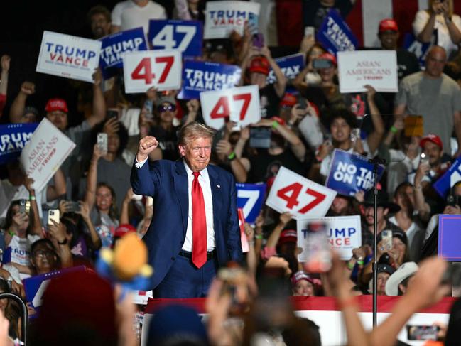 Donald Trump raises a fist on stage during his campaign rally in Las Vegas. Picture: AFP