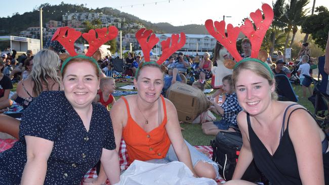 (From left) Meghan Gibson, Laura Goff and Tabitha Field at the Rotary Carols by the Beach 2019 on the Airlie Foreshore. Picture: Elyse Wurm