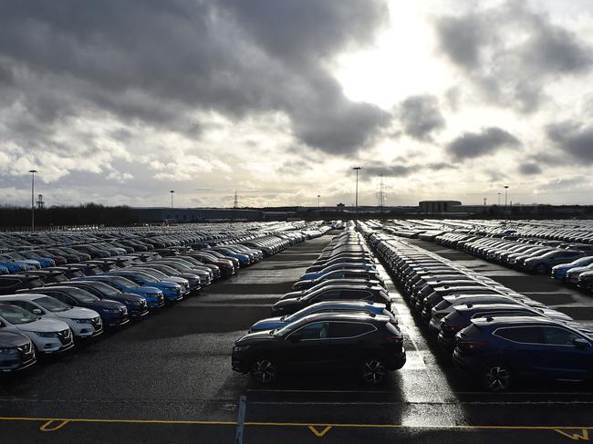 (FILES) In this file photo taken on March 16, 2019, Nissan cars are parked in a lot at its' Sunderland plant in north east England. - Global production of automobiles plunged by 16 percent last year to a level last seen in 2010, the OICA association said on March 25, 2021. With a drop to less than 78 million units sold, the auto sector faced "its worst crisis ever," said the International Organization of Motor Vehicle Manufacturers. (Photo by ANDY BUCHANAN / AFP)