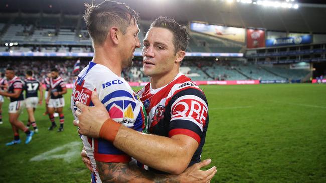 Mitchell Pearce and Cooper Cronk embrace after the Roosters’ win over Newcastle at Allianz Stadium. Picture: Brett Costello