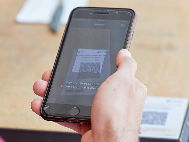 PERTH, AUSTRALIA - DECEMBER 05: A cafe guest scans a QR code using the SafeWA app on December 05, 2020 in Perth, Australia. From Saturday, people in Western Australia will need to register their details when visiting various locations as part of the WA government's introduction of compulsory contact registers and QR codes for COVID-19 contact tracing. (Photo by Stefan Gosatti/Getty Images)