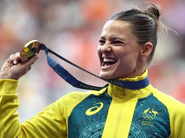 Nina Kennedy celebrates on the podium after winning gold in the women's pole vault final at the Paris Olympics. Picture: AFP