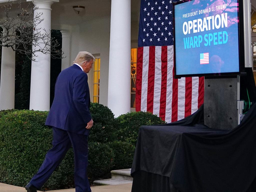 President Trump is bombared with questions as he leave the press conference. Picture: AFP