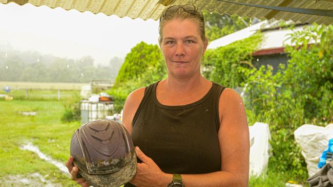 Experienced trainer Angela Ward holds the helmet that saved her life when she fell from a horse in January.