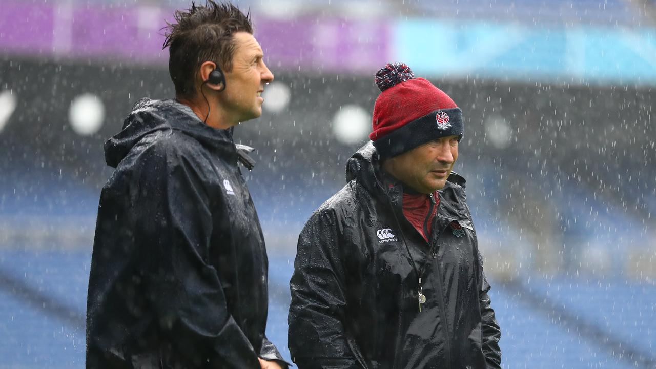 England assistant coach Scott Wisemantel in the rain with head coach Eddie Jones.