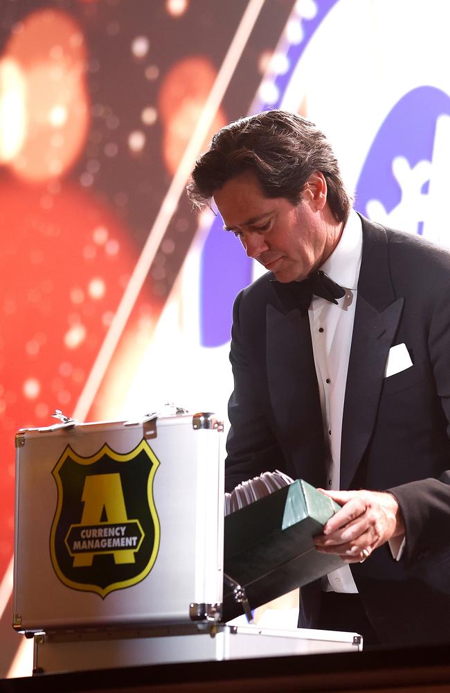 Gillon McLachlan theatrically accepts the Armaguard-protected Brownlow votes one last time on Monday night. Picture: Michael Willson / Getty Images