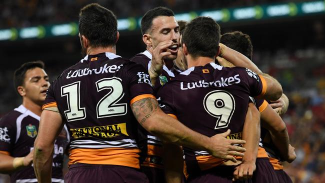 Broncos players celebrate a try against the Dragons at Suncorp Stadium.