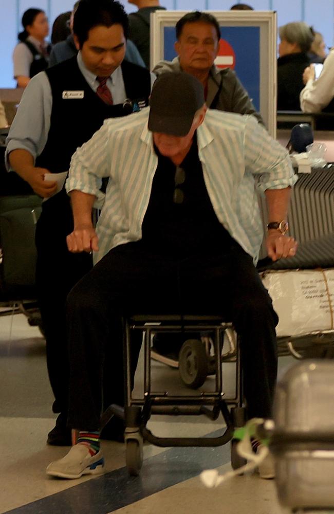 The Baywatch star was seen being assisted by airport staff as he was wheeled through the terminal. Picture: BACKGRID