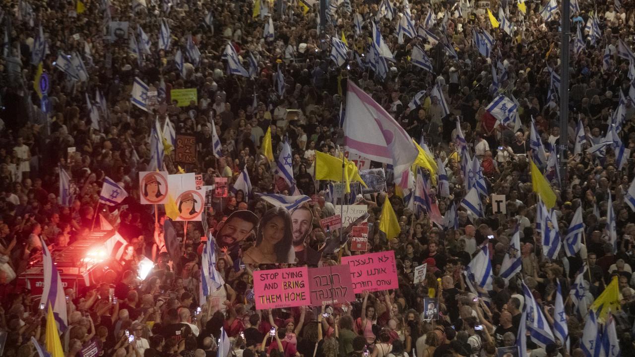 Families of hostages and supporters hold photos and flags during a rally calling for an immediate hostage deal with Hamas. Picture: Amir Levy/Getty Images