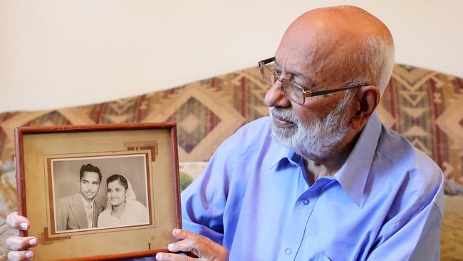 Vijay Maharaj with a wedding photo of himself and his wife Gangotri, who was killed by a cement truck in Crows Nest last week. Picture: Tim Hunter