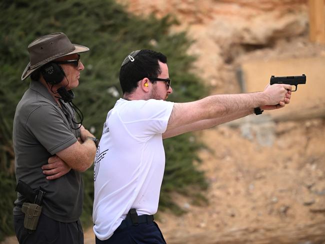 A member of the public receives weapons training from a tutor at the Caliber 3 shooting range in Efrat, Israel. Picture: Getty Images