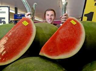 Justin Clinch from Tweed Heads Fruit and Vegetable shop with some nine cent cucumbers. Photo: Blainey Woodham / Daily News. Picture: Blainey Woodham