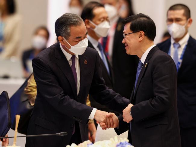 John Lee, right, with Chinese Foreign Minister Wang Yi. Picture: Athit Perawongmetha/AFP