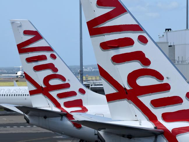 SYDNEY, AUSTRALIA - NCA NewsWire Photos FEBRUARY, 4, 2021: Virgin Australia aircraft are seen on the tarmac at Sydney Domestic Airport, Sydney. Virgin Australia says the end of JobKeeper in March could signal a mass shedding of workers if no further support is provided to the struggling aviation industry which has been out of action for almost one year. Picture: NCA NewsWire/Bianca De Marchi