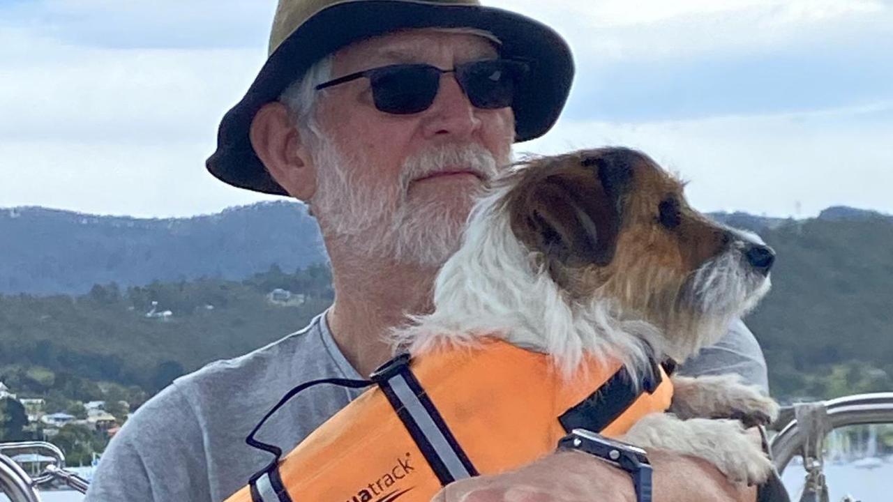 Professor Dennis Pashen with his dog Toby cruises the Channel area in Hobart.