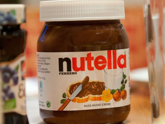 A picture taken on January 8, 2014 shows a pot of Italian hazelnut and cocoa spread "Nutella" on a breakfast table in Inzell, Germany. The maker of the chocolate and hazelnut spread Nutella acknowledged on November 6, 2017 adjusting its formula following a report by a German consumer group. / AFP PHOTO / dpa / Tobias Hase / Germany OUT