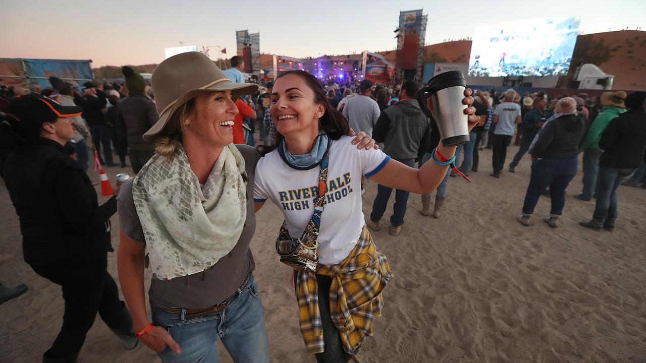 Jo Richards, left, from the NSW Central Coast and Ursula Ogilvie from the Sunshine Coast travelled to the world’s most remote music festival at the base of the Big Red sand dune, west of Birdsville, Queensland. Picture: Lyndon Mechielsen/The Australian