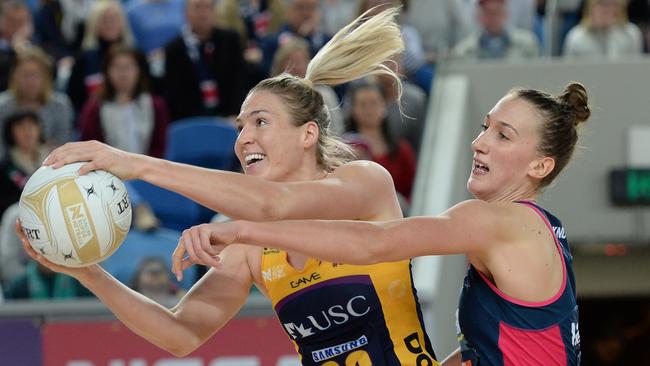 Lightning’s Caitlin Bassett outmuscles Vixen’s Emily Mannix at the Margaret Court Arena