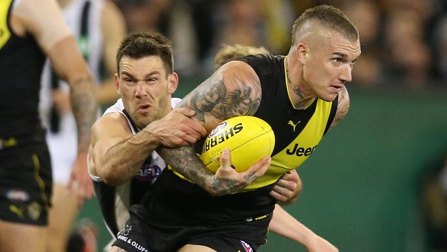 Dustin Martin is tackled by Collingwood’s Levi Greenwood in last year’s preliminary final. Picture: Michael Klein