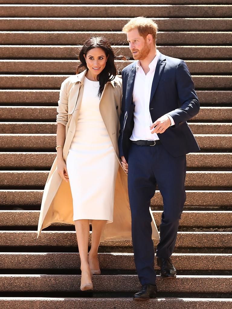 Harry guides his pregnant wife down the Opera House steps. Picture: Getty