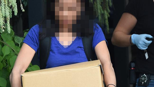 An IBAC officers seizes evidence in raids related to the alleged printing rort. Picture: Nicole Garmston