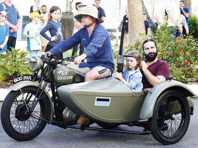 Ross Allen, Bette Allen, 6, and Sam Harms ride in a 1941 BSA motorbike and sidecar used by the Australian Infantry Forces in the Anzac Day parade on the Cairns Esplanade. Picture: Brendan Radke