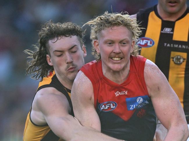 MELBOURNE, AUSTRALIA - MAY 10: Clayton Oliver of the Demons handballs whilst being tackled by Josh Weddle of the Hawks during the round nine AFL match between Melbourne Demons and Hawthorn Hawks at Melbourne Cricket Ground, on May 10, 2025, in Melbourne, Australia. (Photo by Quinn Rooney/Getty Images)