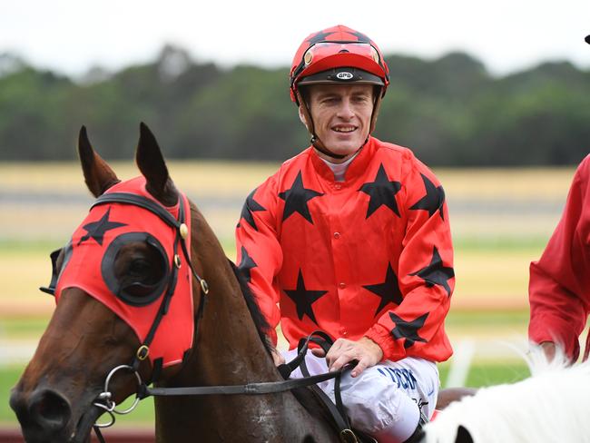 Jockey Jarrod Fry rides Bravo Tango back to scale after winning race 7, the Highways Lunar New Year Handicap during Ladbrokes Park Race Day at Ladbrokes Park racecourse in Melbourne, Wednesday, February 6, 2019. (AAP Image/James Ross) NO ARCHIVING, EDITORIAL USE ONLY