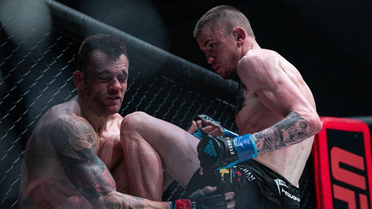 Toowoomba MMA fighter Tom "Big Train" Nolan (right) applies pressure to Trevor Sinclair during their bout at Carrara Stadium on the Gold Coast.