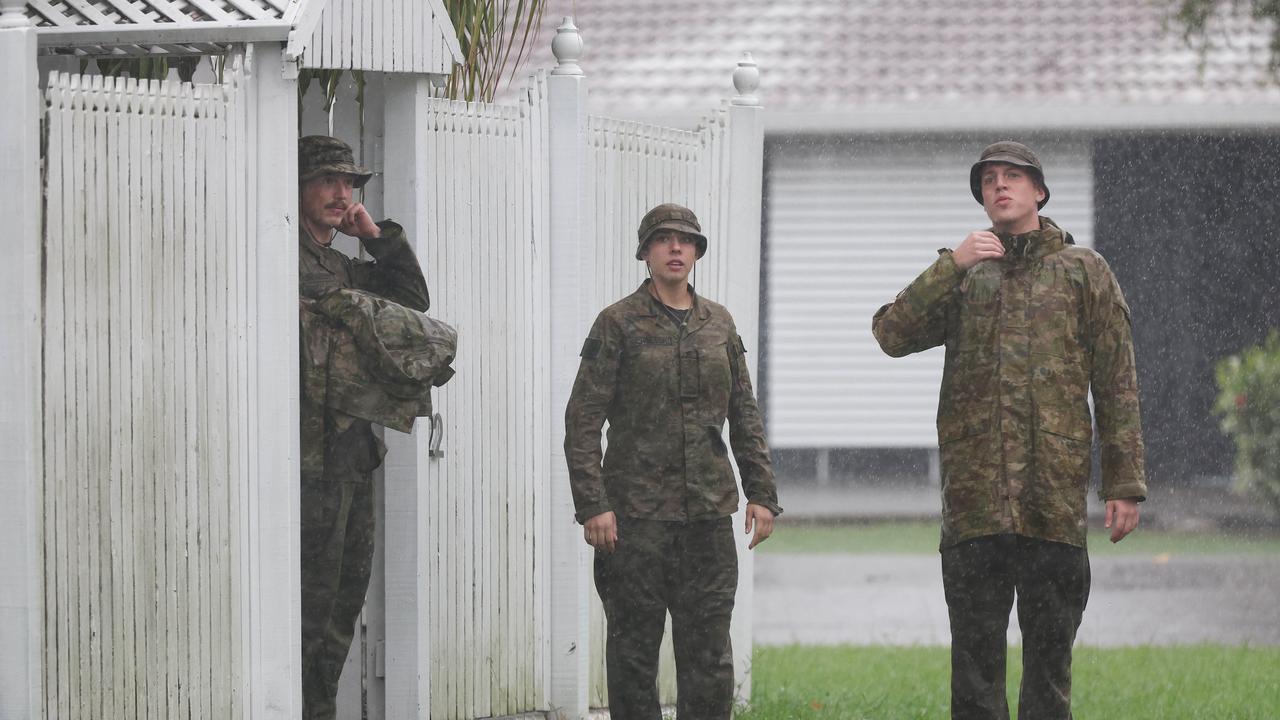 ADF personnel door knocking homes in Hermit Park Townsville as flood waters start to rise. Pics Adam Head