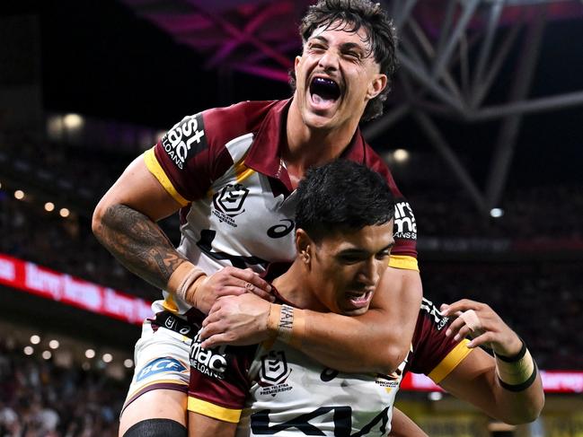 BRISBANE, AUSTRALIA - MAY 17: KotoniÃÂ Staggs of the Broncos jumps on Deine Mariner of the Broncos as they celebrate DeineÃÂ Mariner scoring a try during the round 11 NRL match between Manly Sea Eagles and Brisbane Broncos at Suncorp Stadium, on May 17, 2024, in Brisbane, Australia. (Photo by Hannah Peters/Getty Images)