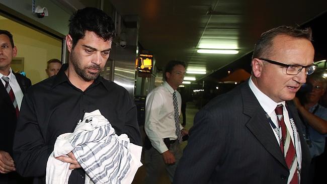 Richard Quincy Williams being led through Gold Coast Airport by detectives after being ex