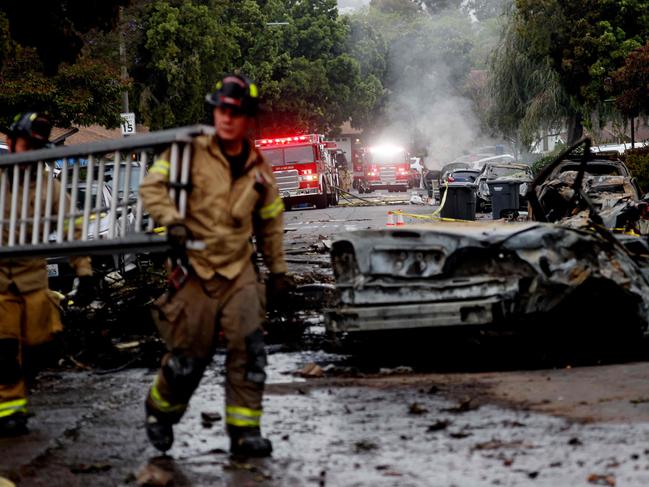 Firefighters work at the scene. Picture: AFP