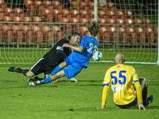 ON TARGET: USQ FC goalkeeper Matt Eilers saves a shot from South West Queensland Thunder Daniel Weber during their FFA Cup clash at Clive Berghofer Stadium. Picture: Kevin Farmer