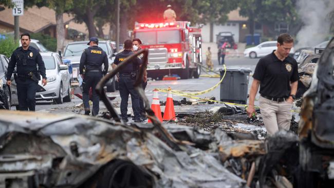 Investigators look through the site ehere a small plane crashed into San Diego, California, residential street on May 22, 2025. Picture: Sandy Huffaker / AFP)