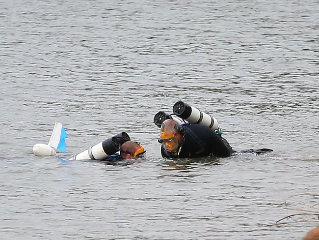 Early this morning divers were searching the water close to the wharf. Picture: Phil Rogers