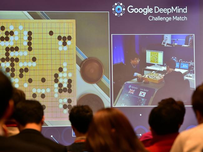 Journalists watch a big screen showing live footage of the third game of the Google DeepMind Challenge Match between Lee Se-Dol, one of the greatest modern players of the ancient board game Go, and the Google-developed supercomputer AlphaGo at a hotel in Seoul on March 12, 2016. Picture: Jung Yeon-Je