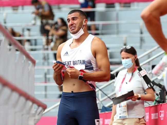 An emotional Adam Gemili of Team Great Britain walks off the track after he pulled up in the heats of the mens 200m. Picture: Getty Images