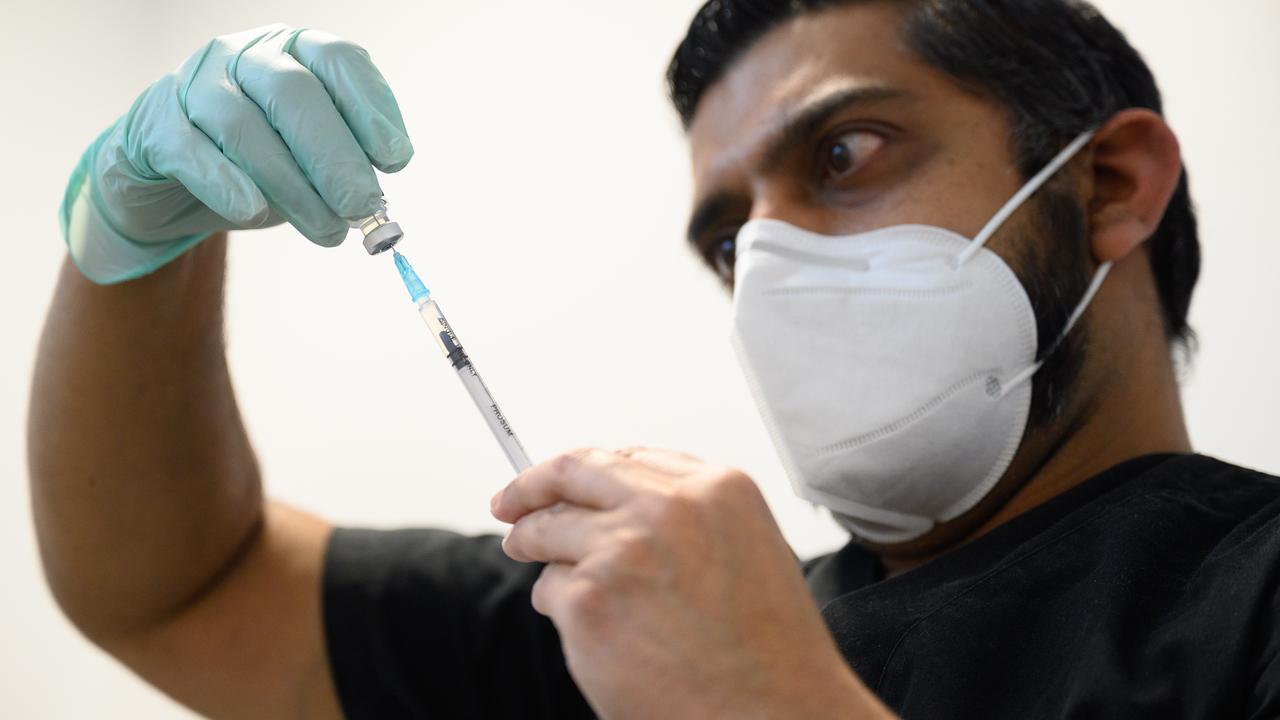 A member of the Newham Health Trust team prepares a dose of the Pfizer/BioNTech COVID-19 vaccine on January 7 in an East London area that has been battered by the virus. Picture: Leon Neal/Getty Images