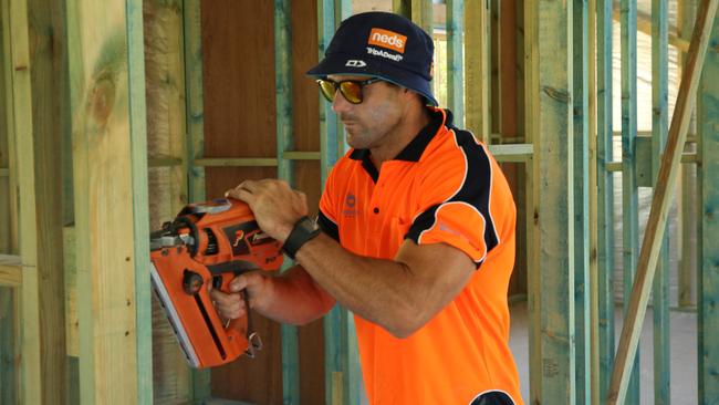 Fullback Michael Gordon gets to grips with a nail gun.