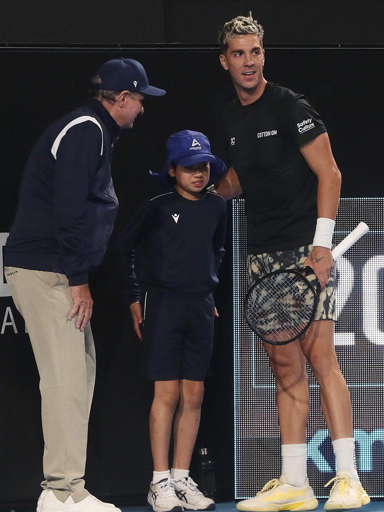 Thanasi Kokkinakis comforts the ball boy who was hit by a 208km/h serve. Picture: Sarah Reed/Getty Images