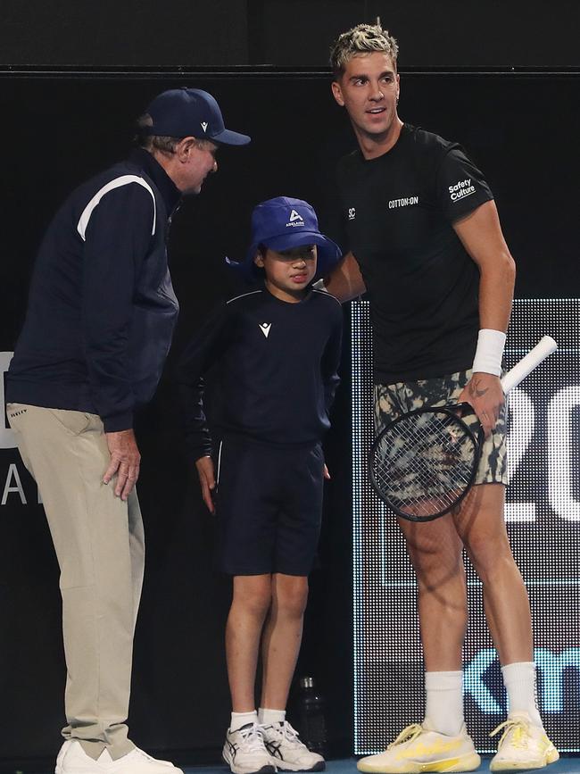 Thanasi Kokkinakis comforts the ball boy who was hit by a 208km/h serve. Picture: Sarah Reed/Getty Images