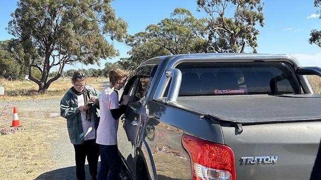 Protesters speak with Steve Crawford, who showed up to the protest and told the activists that Olivia had been moved to a “beautiful site’. Picture: Oscar Jaeger